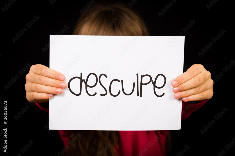Child holding sign with Portuguese word Desculpe - Sorry Child holding sign with Portuguese word Desculpe - Sorry