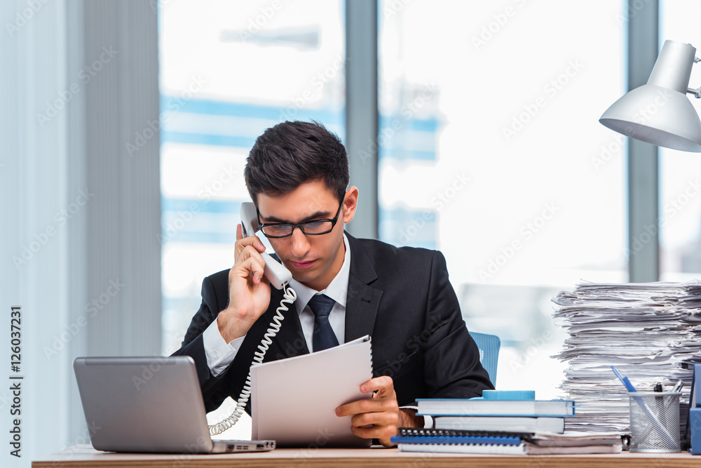 Young businessman talking on the phone Young businessman talking on the phone