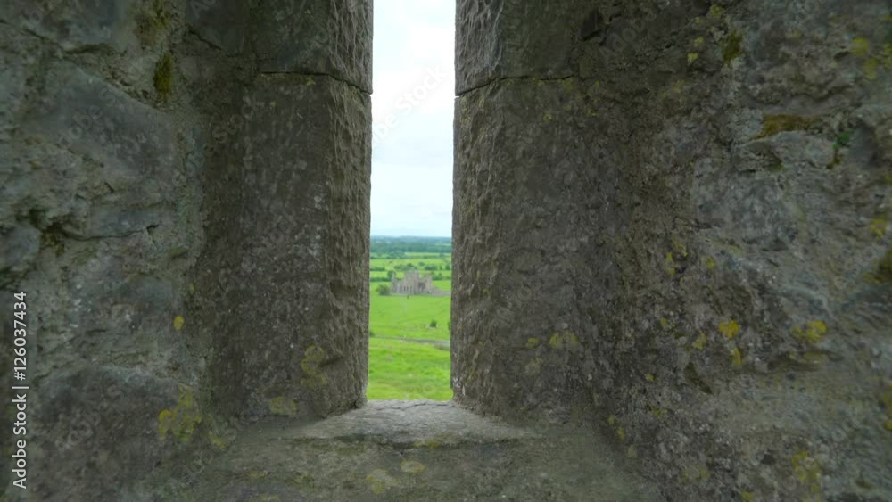 The small hole with the view of the Hore Abbey in the Rock of Cashel in Ireland The small hole with the view of the Hore Abbey in the Rock of Cashel in Ireland