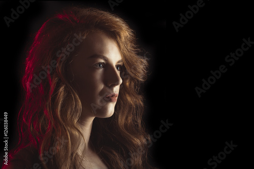 Splendid young woman in the dark. Space for text