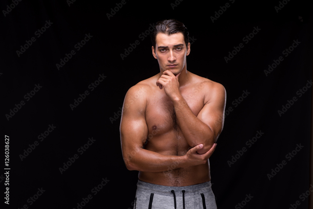 Fototapeta premium Ripped muscular man on black background