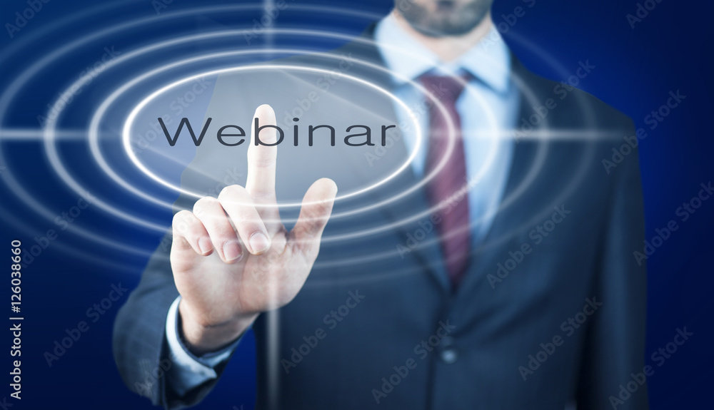 Businessman pressing a webinar Businessman pressing a webinar