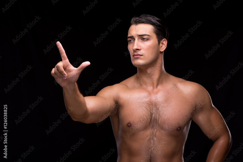 Fototapeta premium Ripped muscular man pressing virtual buttons