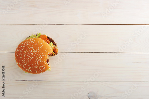 bitten bbq hamburger with vegetables, spices