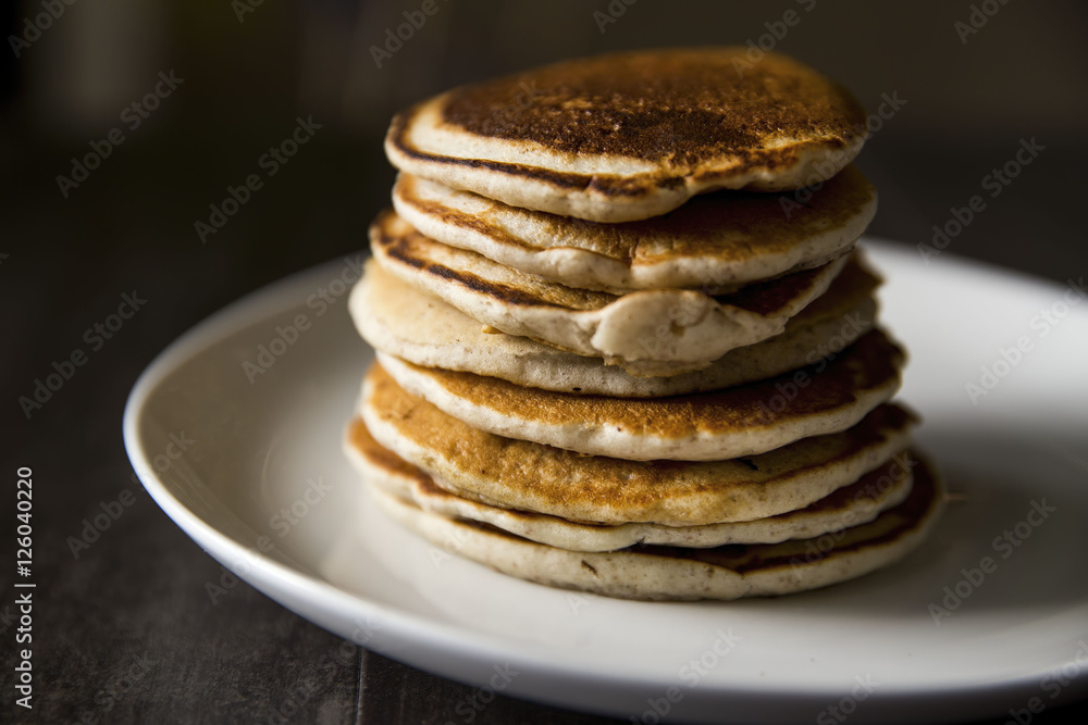 Stack of Golden Brown Pancakes on a White Plate for Morning Breakfast or Brunch Stack of Golden Brown Pancakes on a White Plate for Morning Breakfast or Brunch