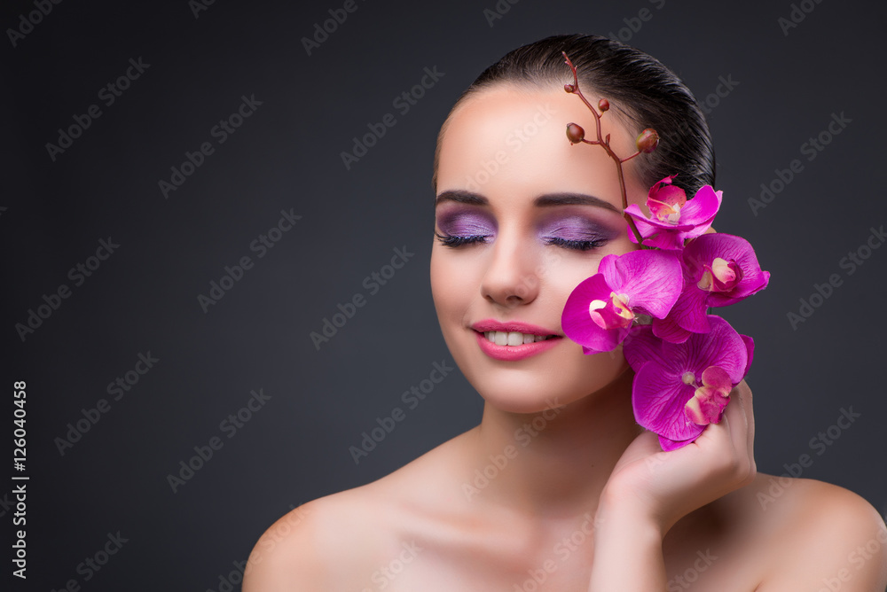 Young beautiful woman with orchid flower Young beautiful woman with orchid flower