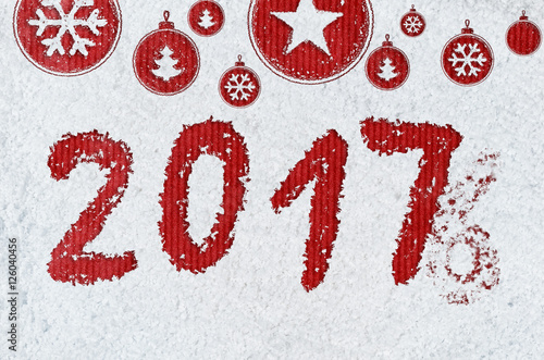 christmas card or new year background made of xmas symbols handwritten on snow and red craft paper