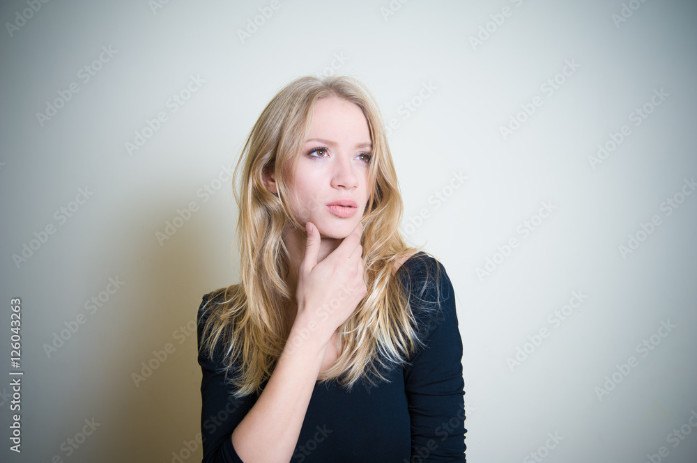 Fototapeta premium Thoughtful young blonde woman portrait