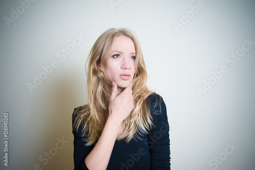 Thoughtful young blonde woman portrait