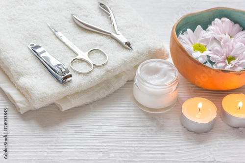 spa nail care with tea candle on wooden background