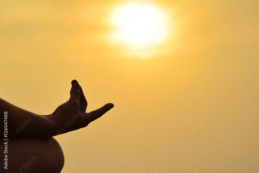Young woman practicing yoga on morning sunshine with copy space