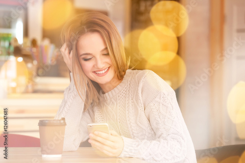 Young woman with smartphone...