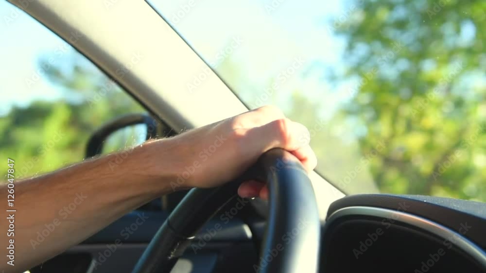 Man driving his car. Man's hand on steering wheel closeup. 1080p HD video footage Man driving his car. Man's hand on steering wheel closeup. 1080p HD video footage