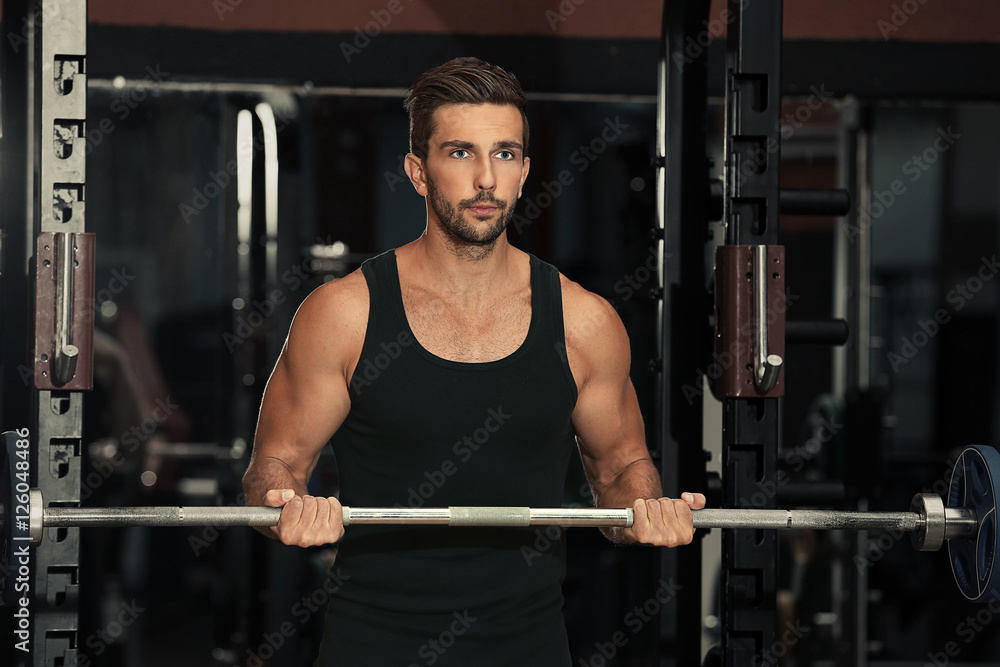 Young man training in fitness gym Young man training in fitness gym