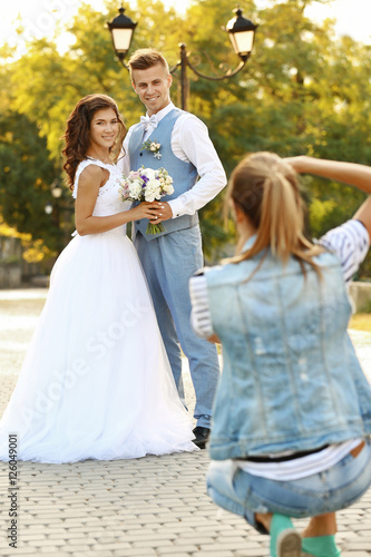 Young woman taking photo of...