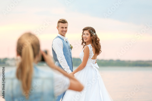 Young woman taking photo of...