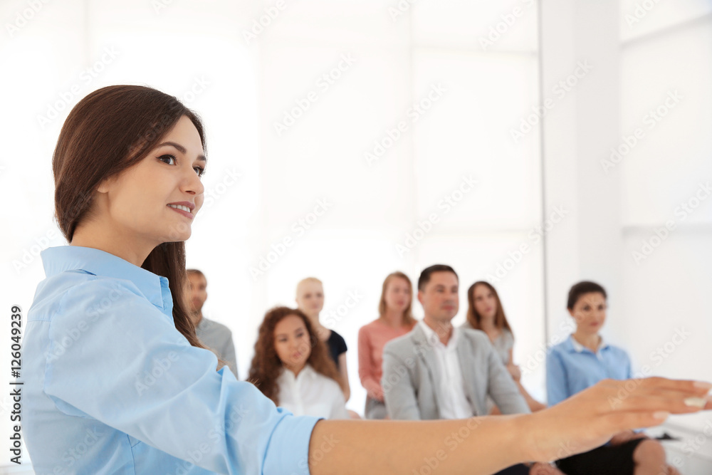 Business trainer giving presentation to group of people Business trainer giving presentation to group of people