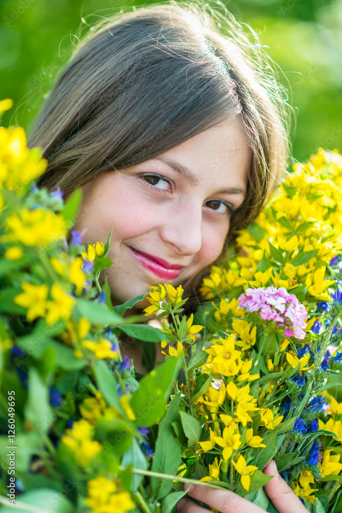 Portrait of a girl with flowers in the garden Portrait of a girl with flowers in the garden