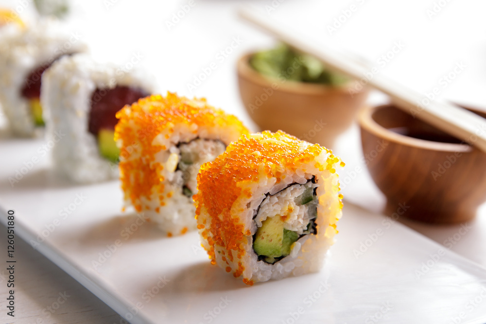 california roll and tuna avocado roll on white plate california roll and tuna avocado roll on white plate
