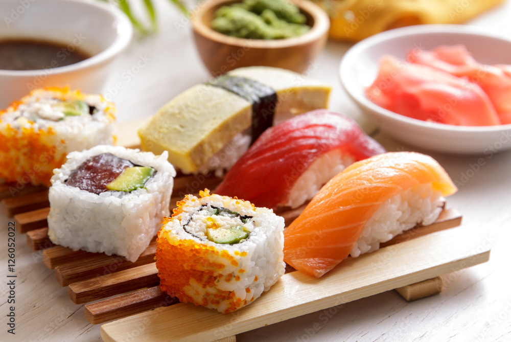 Sushi Set nigiri sushiand maki sushi served on wooden plate Sushi Set nigiri sushiand maki sushi served on wooden plate