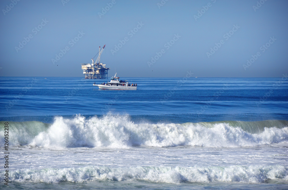 oil platform and fishing boat on ocean oil platform and fishing boat on ocean