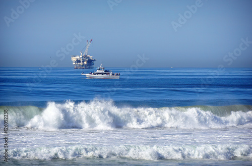oil platform and fishing boat on ocean