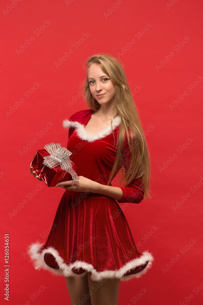 girl on a red background holds gift box girl on a red background holds gift box