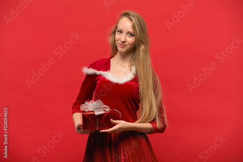 girl on a red background holds  gift box