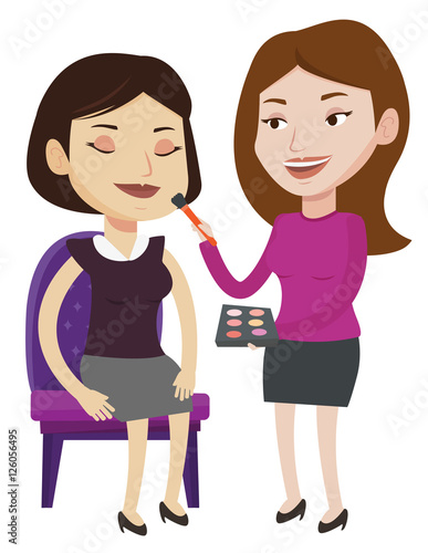 Visagiste doing makeup to young girl.