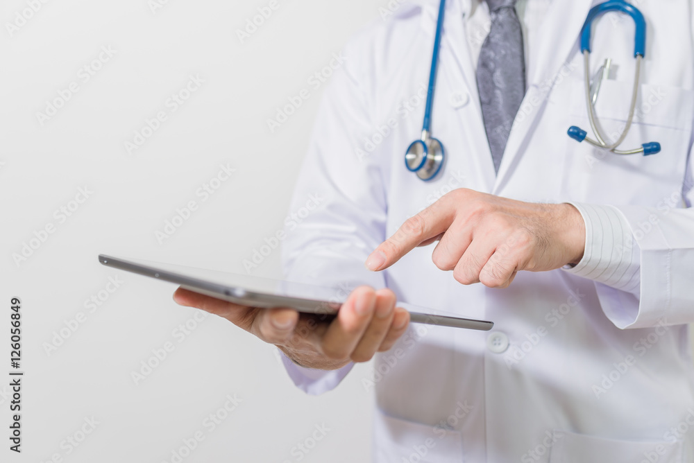 Doctor using a digital tablet on white background Doctor using a digital tablet on white background