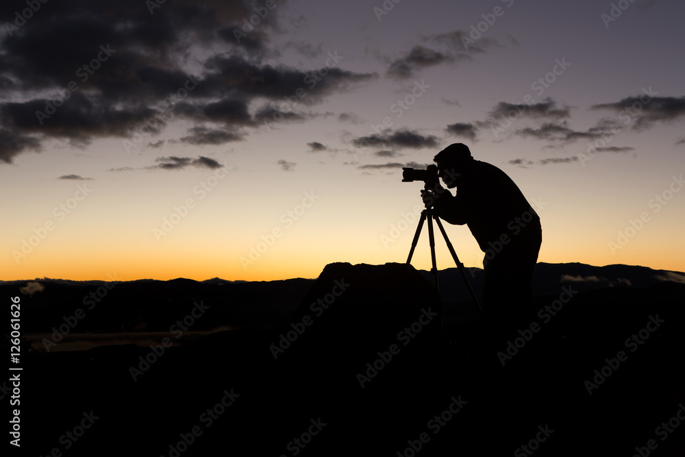 Silhouette of a photographer at sunrise