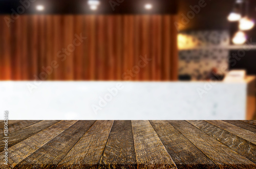 image of wooden table in front of abstract blurred background of