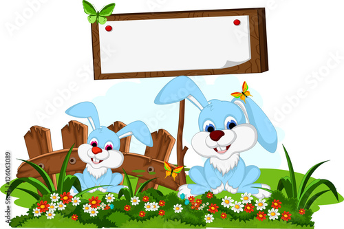Fototapeta Naklejka Na Ścianę i Meble -  two rabbit cartoon posing with blank sign