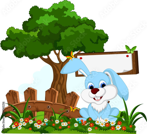 Fototapeta Naklejka Na Ścianę i Meble -  rabbit cartoon posing with blank sign in flower garden
