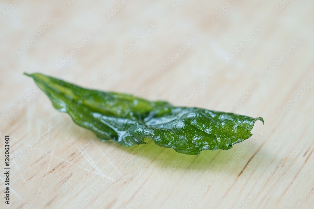 Holy basil fried on a wooden cutting board