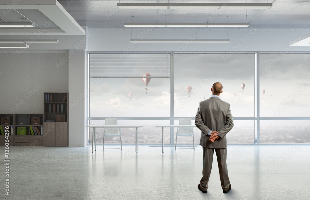 Fototapeta premium Pensive businessman in office . Mixed media