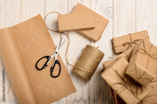 Wrapping Christmas gifts in Kraft paper and rope.