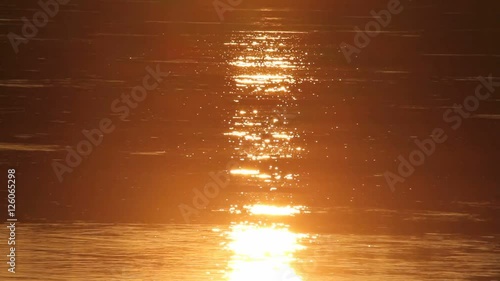 Water surface of river Elbe, in Germany, reflecting a colored sunset