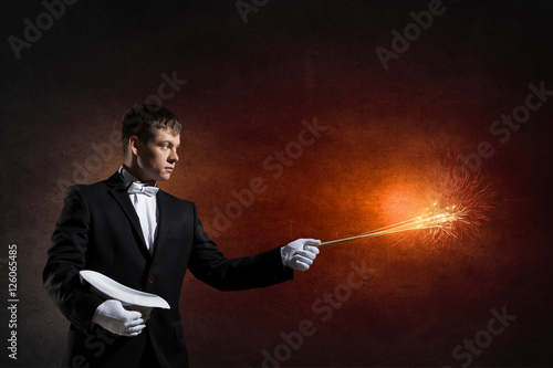 Foto Businessman demonstrating magic . Mixed media