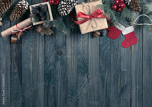 Christmas background with spruce, gift box, Santa Claus boots, m