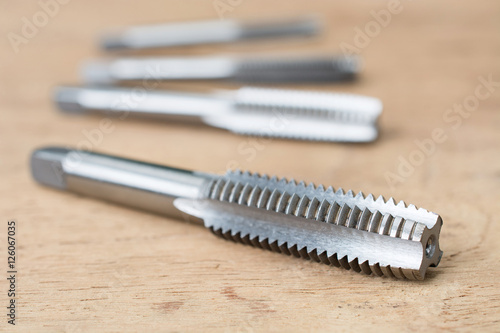 Screw tap cutting tool and broach on wood table