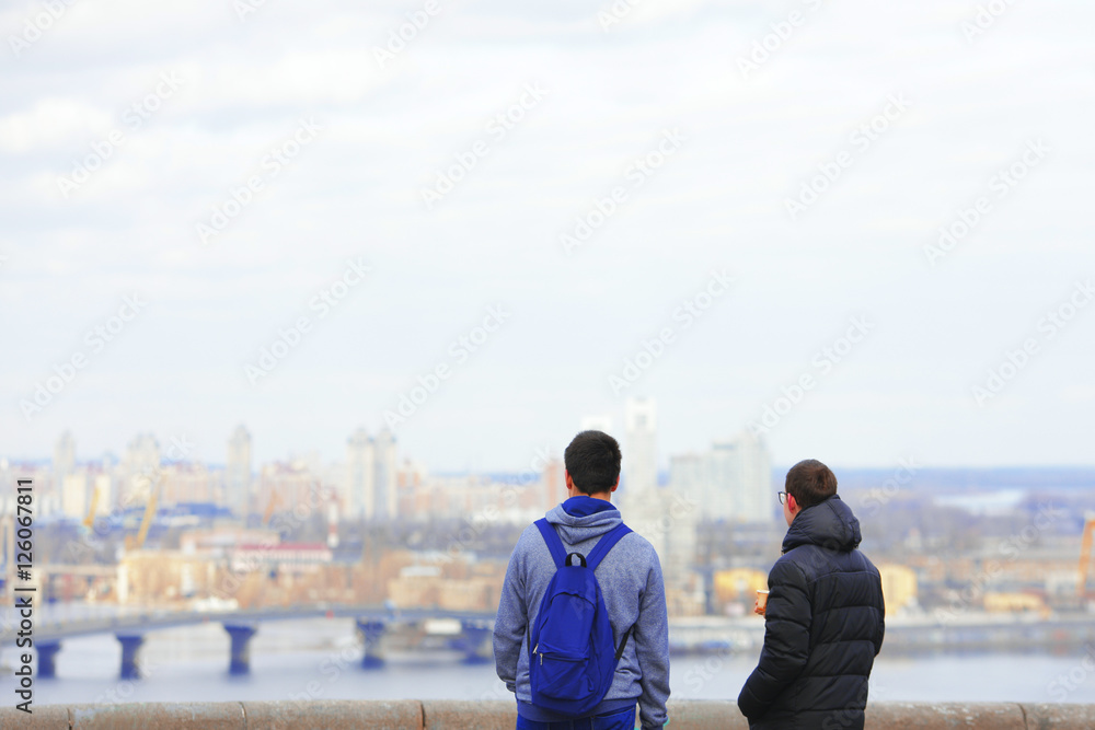 young people look at the city from a height