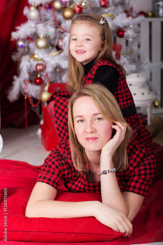 Daughter and mother near Christmas tree. Daughter and mother near Christmas tree.