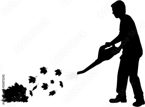 Silhouette of a man with a leaf blower.