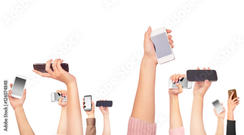 Many hands holding mobile phones on white