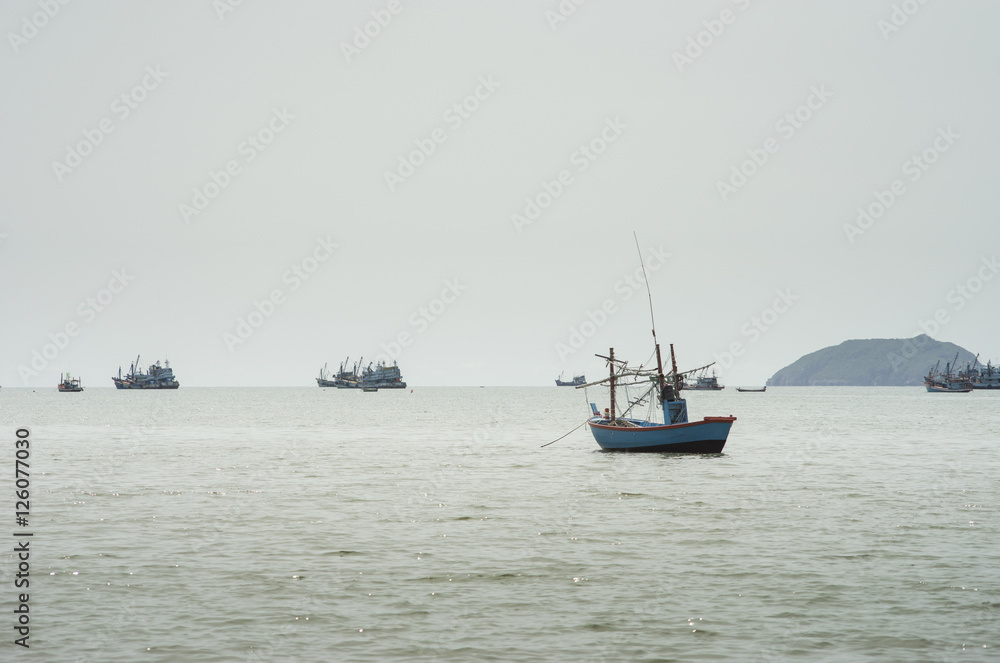 traditional fishing boat laying on the sea.cloudy sky.filtered image.selective focus traditional fishing boat laying on the sea.cloudy sky.filtered image.selective focus