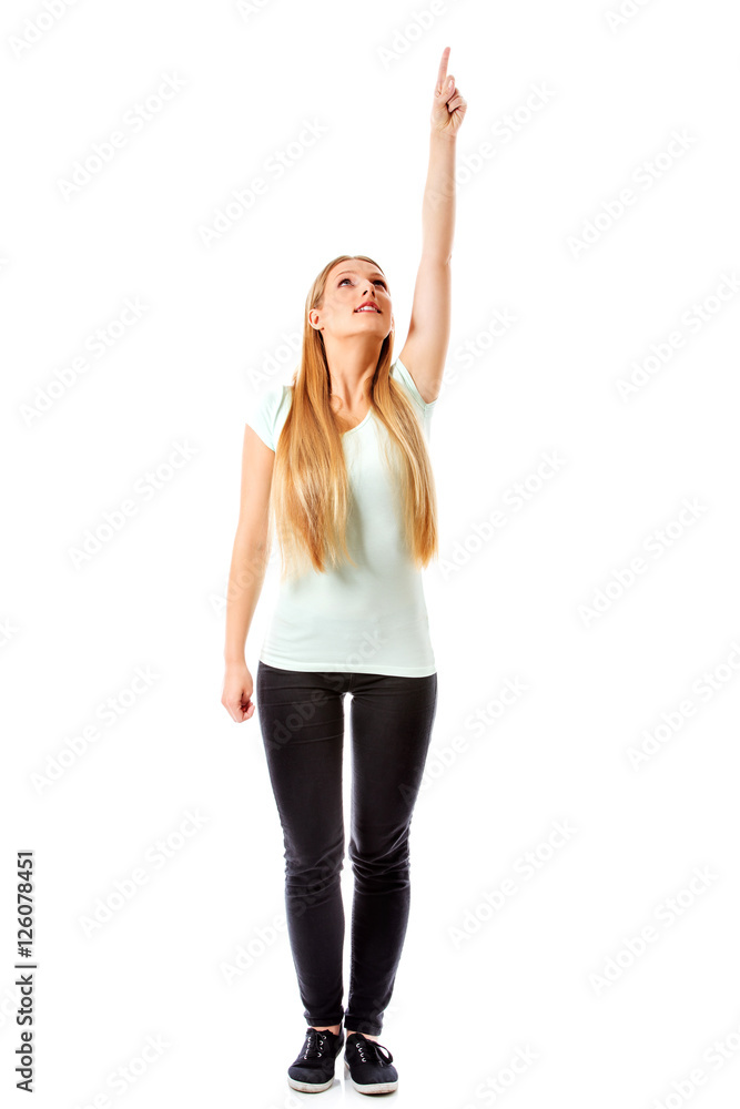 A beautiful girl is pointing up with her hand - isolated on white. A beautiful girl is pointing up with her hand - isolated on white.