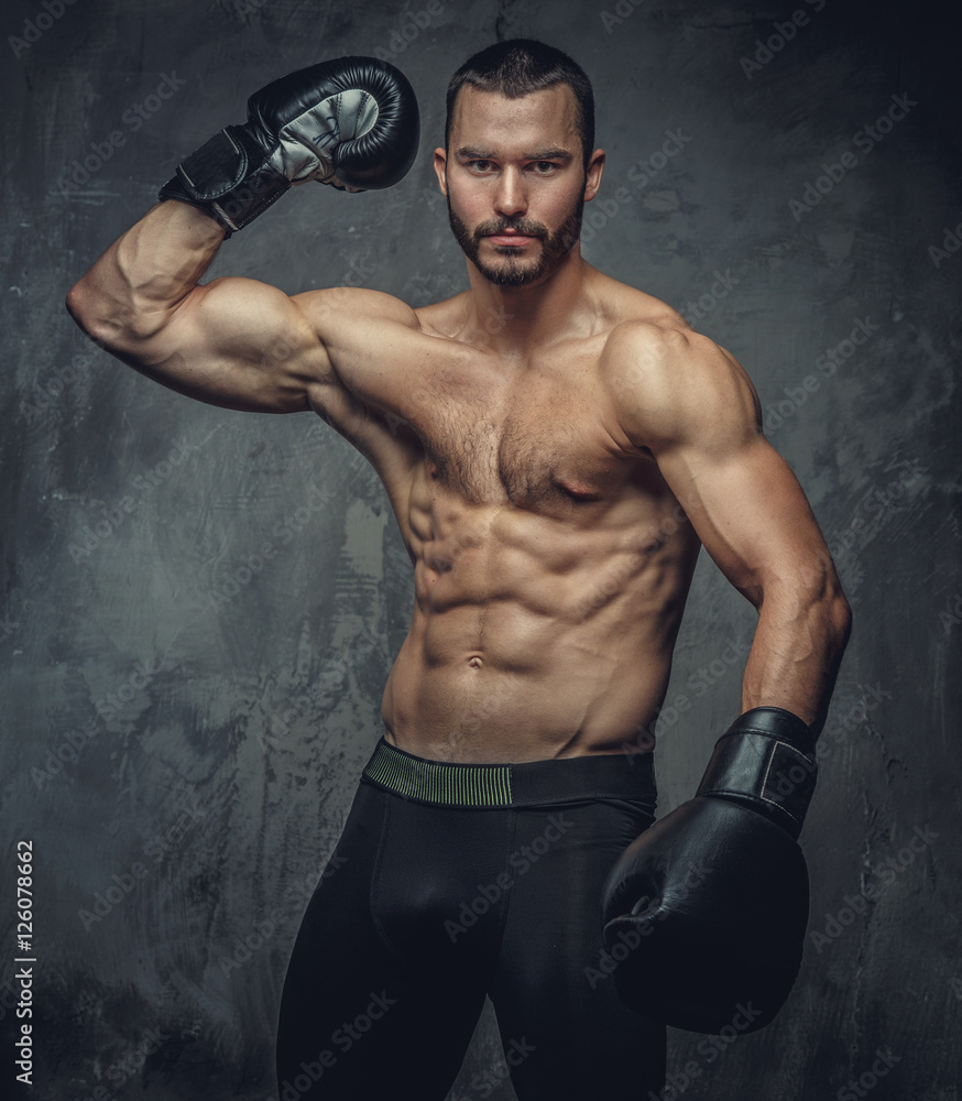 Brutal boxer fighter on grey background.