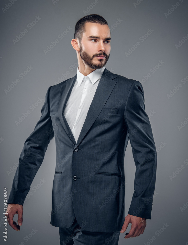 A man in a suit isolated on grey background. A man in a suit isolated on grey background.