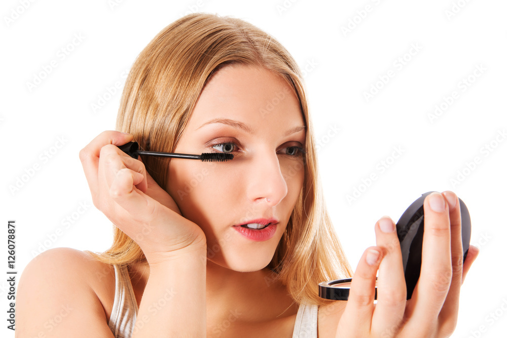 Attractive woman doing make-up on face. Isolated Attractive woman doing make-up on face. Isolated